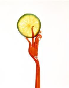 A slice of lime with bent plastic fork