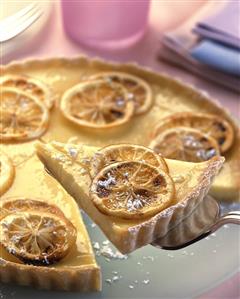 Lemon tart, pieces cut, one piece on cake slice