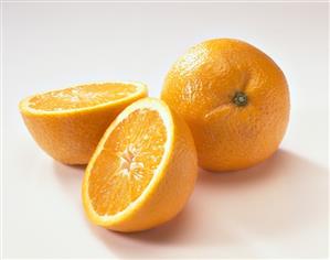One halved and one whole orange
