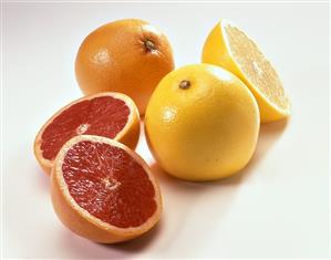 Pink and yellow grapefruit, whole and cut open