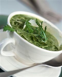 Rocket soup with Parmesan curls in soup cup