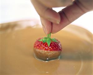 Dipping strawberries in melted chocolate (1)