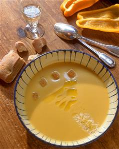 Yellow pepper cream soup with croutons, olive oil & parmesan