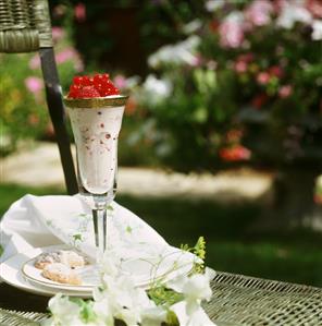 Yoghurt mousse with raspberries and redcurrants in glass