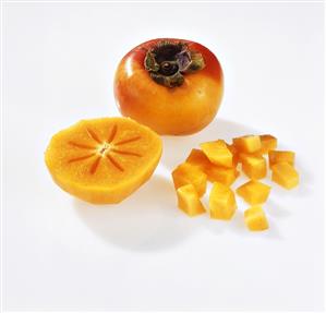 Sharon fruit: whole, halved and in pieces