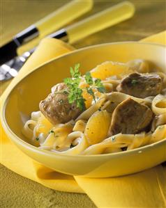 Ribbon noodles with pork medallions & orange sauce