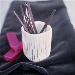 Chocolate matchsticks in a beaker