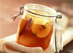 Apples in Campari and white wine in preserving jar