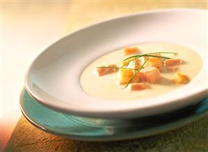 Cream of potato soup with salmon and croutons