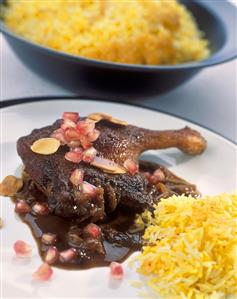 Roast duck leg with saffron rice and pomegranate sauce