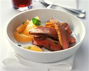 Pink roast duck breast with grapefruit segments