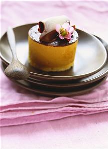 Caramel flans with chocolate icing and flower