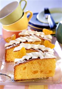 A few pieces of mandarin cake on cake plate