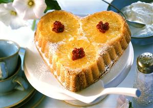 Heart-shaped pineapple cake with redcurrants