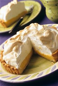 A pineapple meringue pie, piece cut