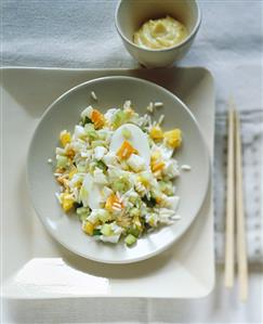 Rice salad with boiled egg, pineapple, vegetables & curry sauce