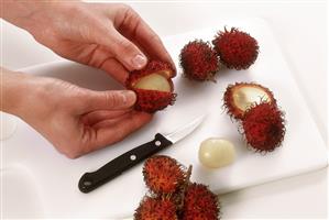 Peeling a rambutan