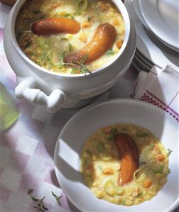 Pea soup with sausages in a soup tureen