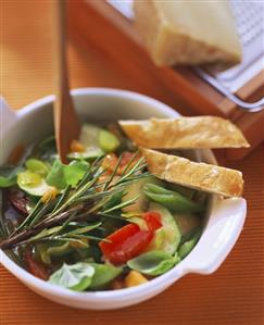 A bowl of vegetable stew with fresh herbs