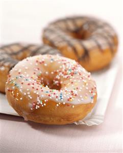 Doughnuts with sugar pearls and with chocolate icing