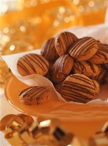 Gingernuts with chocolate icing in a bowl