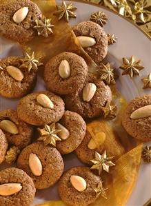 Chocolate almond macaroons with stars on gold-rimmed plate