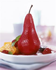 Red wine pear, decorated with fresh fruit