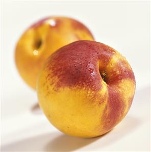 Two nectarines with dew drops