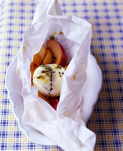 Baked goat's cheese with plums in baking parchment