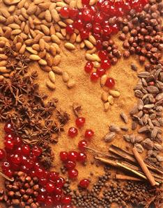 Spices, nuts, almonds and cherries forming a surface