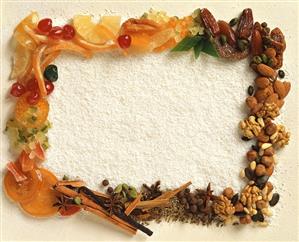 Frame of nuts, spices, fruits on grated coconut