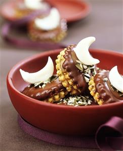 Pumpkin seed biscuits with chocolate icing & marzipan moons