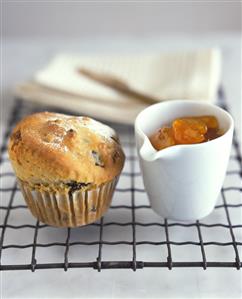 Fruit muffin and a pot of apricot jam