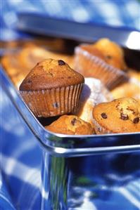 Chocolate chip muffins and donuts in a tin