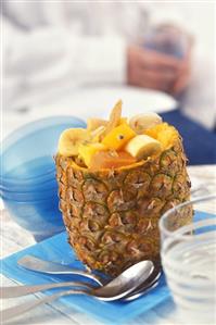 Tropical fruit salad, served in hollowed-out pineapple