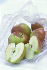 Apples in an opened plastic bag