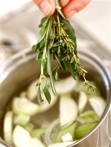 Adding herbs to soup