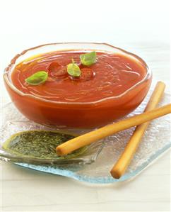 Cold tomato soup, pesto and grissini beside it (1)