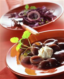 Plum compote with cinnamon cream, red cabbage salad behind