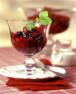 Red fruit compote in a glass bowl