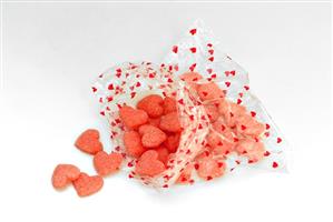 Heart-shaped sweets in a plastic bag printed with hearts