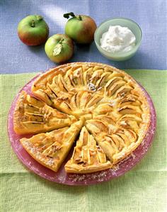 Apple tart with pine nuts, a piece cut