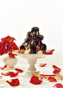 Profiterole pyramid with warm chocolate sauce