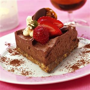 Piece of chocolate mousse gateau with strawberries