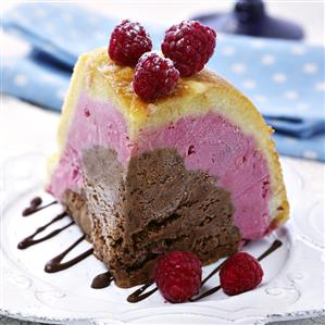 A piece of chocolate and raspberry iced bombe