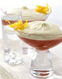 Plum jelly with whipped cream in dessert bowls