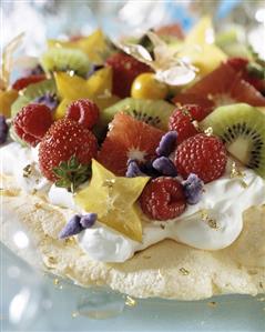 Pavlova with exotic fruit and berries