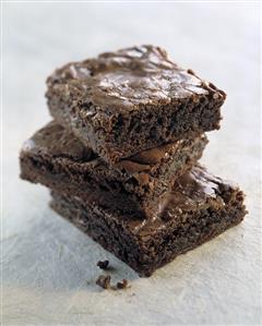 Three brownies with chocolate fondant icing