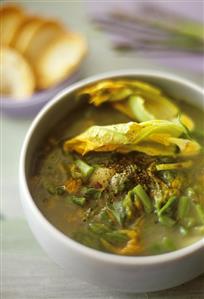 Vegetable soup with green wild asparagus & courgette flowers