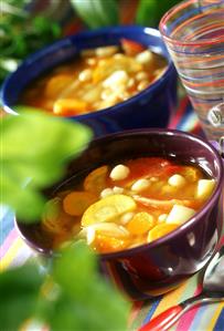 Vegetable soup with tomatoes, root vegetables and beans